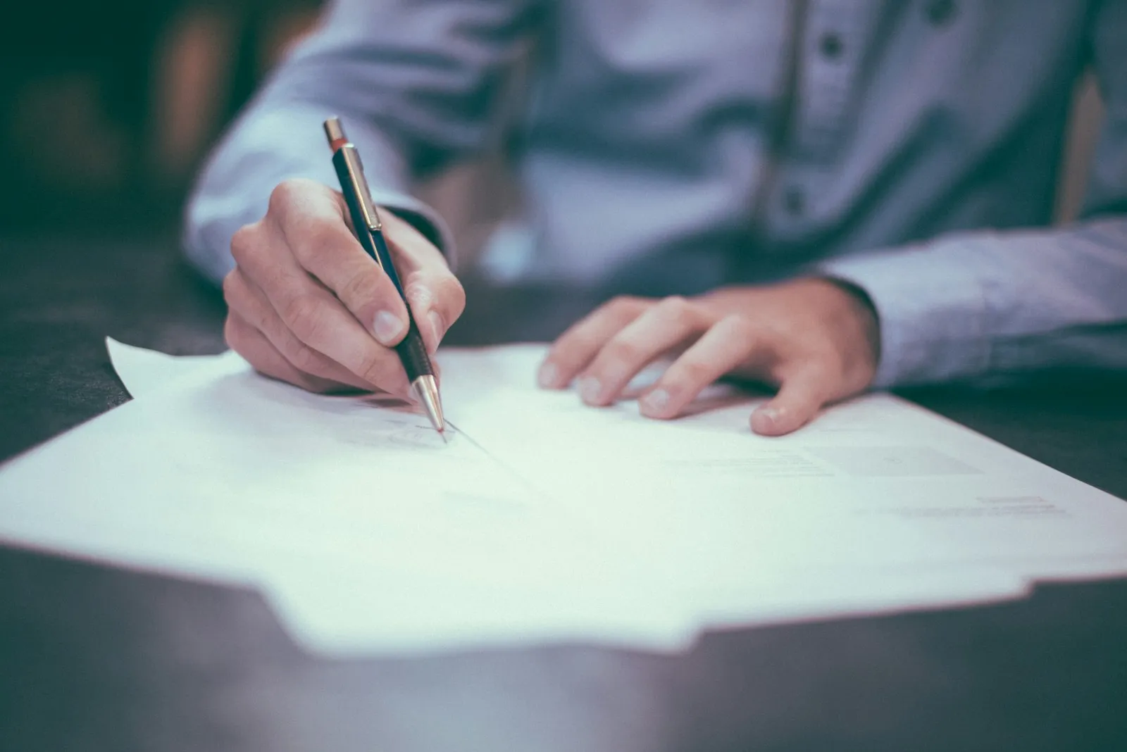 Legal professional reviewing and signing a document